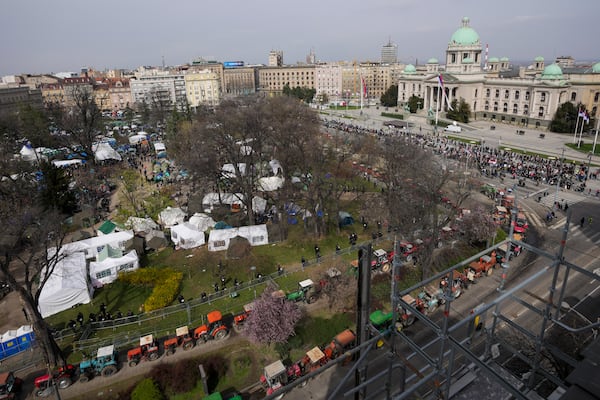 A view of students and former paramilitary fighters loyal to President Aleksandar Vucic camp outside the presidency building prior to a major anti-corruption rally in downtown Belgrade, Serbia, Saturday, March 15, 2025. (AP Photo/Darko Vojinovic)