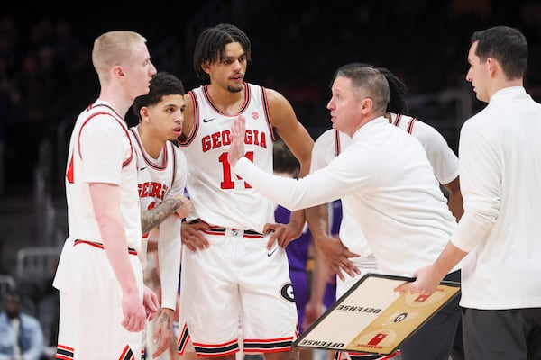 Georgia head coach Mike White, right, talks with Georgia guard Blue Cain (0), Georgia guard Dakota Leffew (1), and Georgia forward Asa Newell (14) during the second half against Grand Canyon in the Holiday Hoopsgiving tournament at State Farm Arena, Saturday, December 14, 2024, in Atlanta. Georgia won 73-68. (Jason Getz / AJC)
