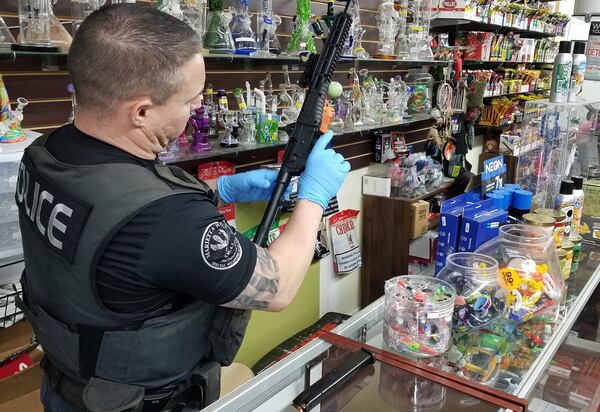 Marietta police raided two businesses and seized more than 100 pounds in suspected drugs Tuesday.