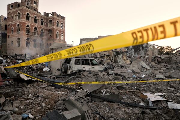 Locals inspect the site reportedly struck by U.S. airstrikes overnight in Sanaa, Yemen, Thursday, March 20, 2025. (AP Photo)