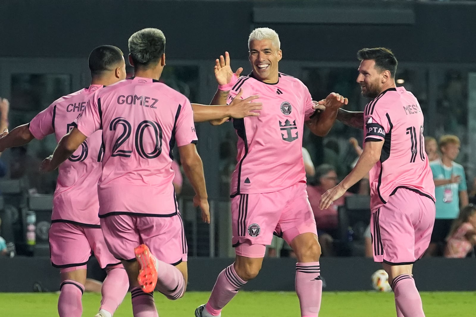 Inter Miami forward Luis Suarez (9), center, is congratulated by his teammates after scoring a goal during the first half of an MLS playoff soccer match against the Atlanta United, Friday, Oct. 25, 2024, in Fort Lauderdale, Fla. (AP Photo/Lynne Sladky)