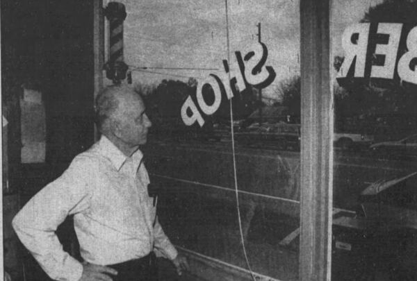 When Earl Brown, 84, began cutting hair the price was 15 cents and President Franklin D. Roosevelt was the main topic of discussion in the barbershop, where the main source of heat was a coal-burning stove that provided warm water for shaving. Photo taken in 1990. (Bob Harrell, The Atlanta Journal-Constitution)