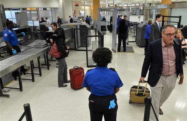 JANUARY 15, 2014 ATLANTA TSA agents man the checkpoint for pre-cleared passengers Wednesday. The Transportation Security Administration (TSA) officially opened an application site at Hartsfield-Jackson Atlanta International Airport (ATL) Wednesday, January 15, 2014, for TSA Pre (TM), an expedited screening program that allows travelers to leave on their shoes, light outerwear and belt, keep their laptop in its case and keep 3-1-1 compliant liquids/gels bag in a carry-on bag. U.S. citizens and lawful permanent residents will now be able to go through a pre-enrollment process online at www.TSA.gov, make an appointment and complete their enrollment at the application center at gate A19 to verify their identity and provide documentation to confirm their citizenship/immigration status as well as to provide fingerprints. TSA is currently in the process of expanding to more than 300 application centers across the country. The application center at Hartsfield-Jackson Atlanta International Airport is one of the first centers to open in the southeast. KENT D. JOHNSON / KDJOHNSON@AJC.COM