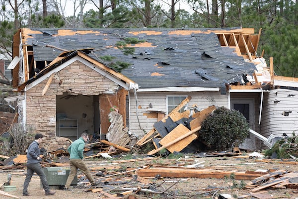 National Weather Service employees survey the tornado damage homes in the Lexington Park neighborhood in LaGrange Friday, Jan 13, 2023.   (Steve Schaefer/steve.schaefer@ajc.com)