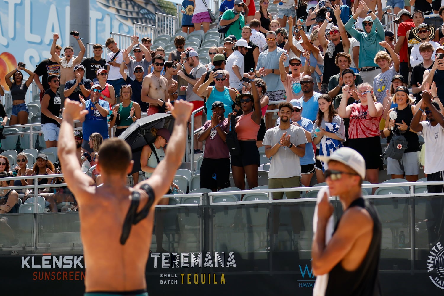 The crowd celebrates the victory with Paul Lotman and Miles Partain after the AVP Gold Series Atlanta Open men's championship match Sunday at Atlantic Station. (Miguel Martinez / miguel.martinezjimenez@ajc.com)