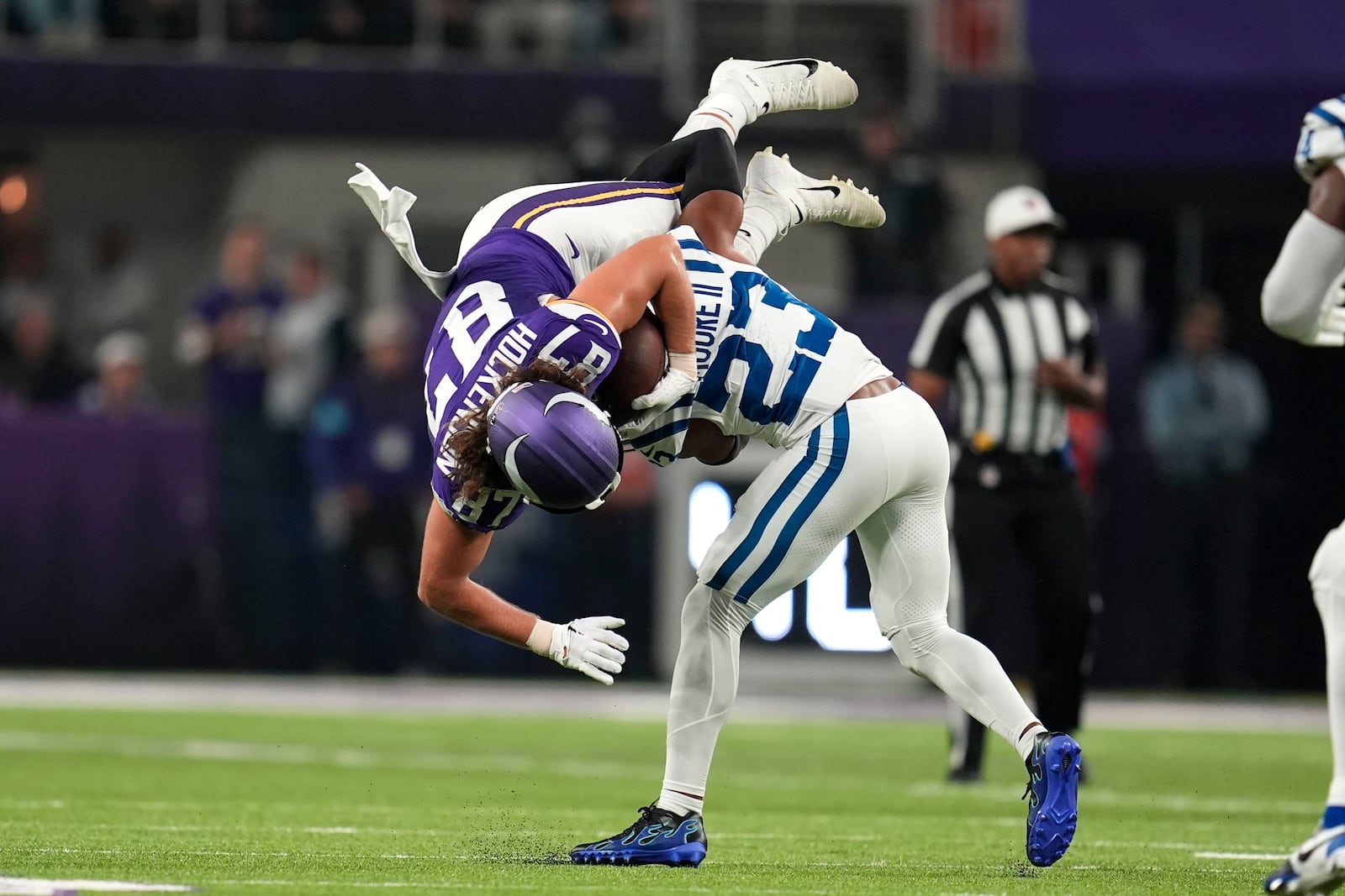 Minnesota Vikings tight end T.J. Hockenson (87) is tackled by Indianapolis Colts cornerback Kenny Moore II (23) after catching a pass during the first half of an NFL football game, Sunday, Nov. 3, 2024, in Minneapolis. (AP Photo/Abbie Parr)