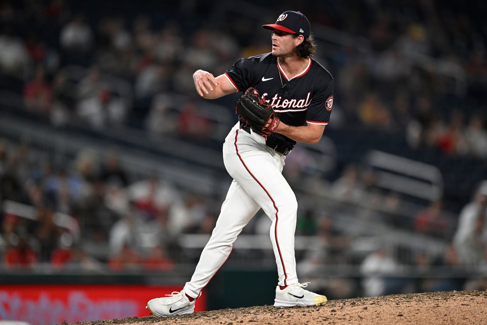 Washington Nationals relief pitcher Kyle Finnegan follows through on a pitch during the ninth inning of a baseball game against the Atlanta Braves, Wednesday, Sept. 11, 2024, in Washington. (AP Photo/John McDonnell)