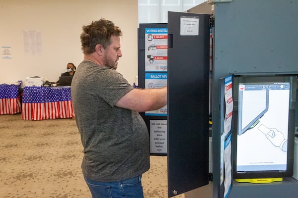 David Watkins casts his vote at the Metropolitan Library in Atlanta on the last Saturday of early voting, May 14, 2022, in this year's general primary. (Photo: Steve Schaefer / steve.schaefer@ajc.com)