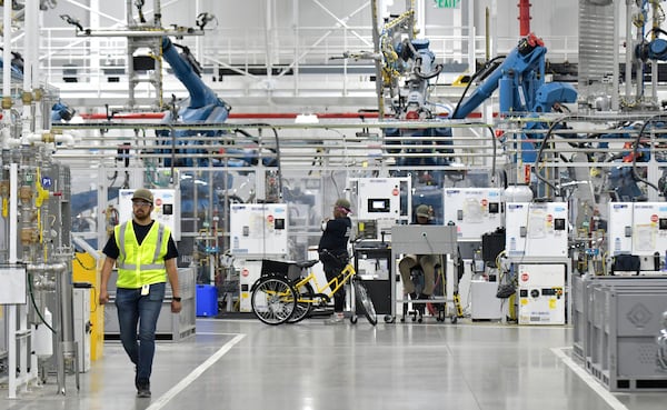 Manufacturing workers assemble electric vehicles at Rivian in Normal, Ill., on July 20, 2022. (Photo for The Atlanta Journal-Constitution by Ron Johnson)