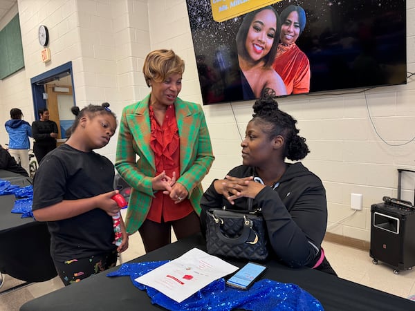 State Sen. Sonya Halpern (center), an Atlanta Democrat, speaks with Shandreka Robinson, right, and her 11-year-old daughter, Earlisia Davidson, during an event on Thursday at Finch Middle School.