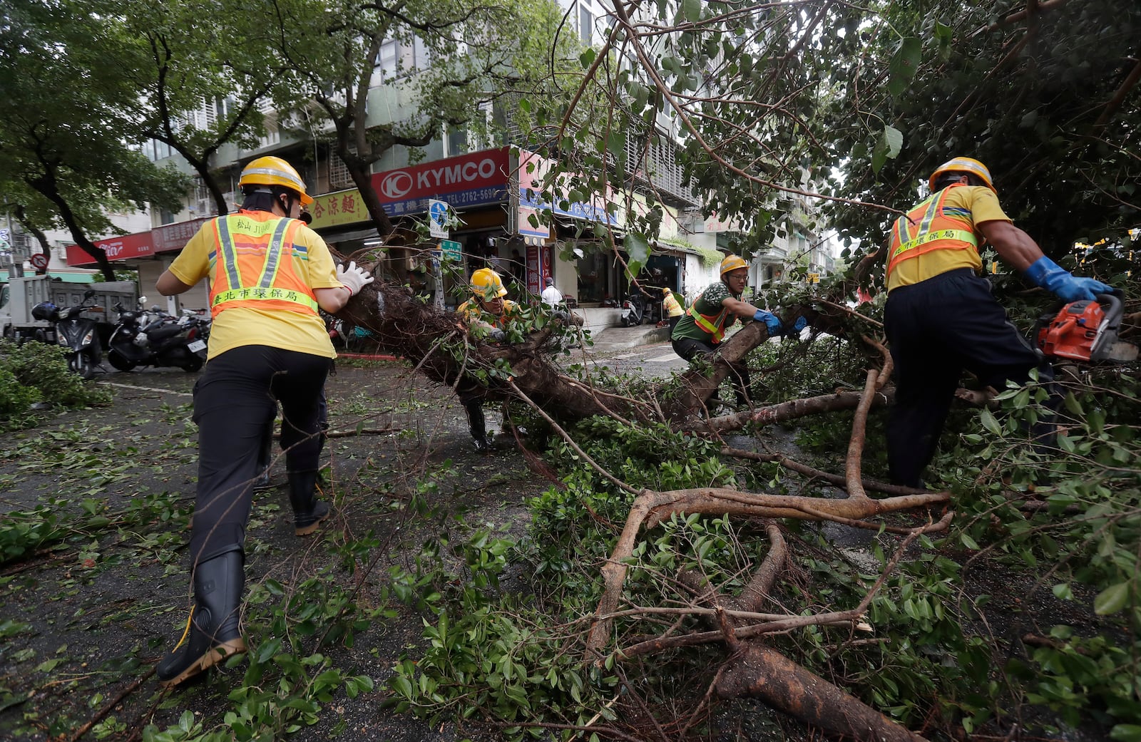 Sanitation workers of Taipei city government clear debris in the aftermath of Typhoon Kong-rey in Taipei, Taiwan, Friday, Nov. 1, 2024. (AP Photo/Chiang Ying-ying)