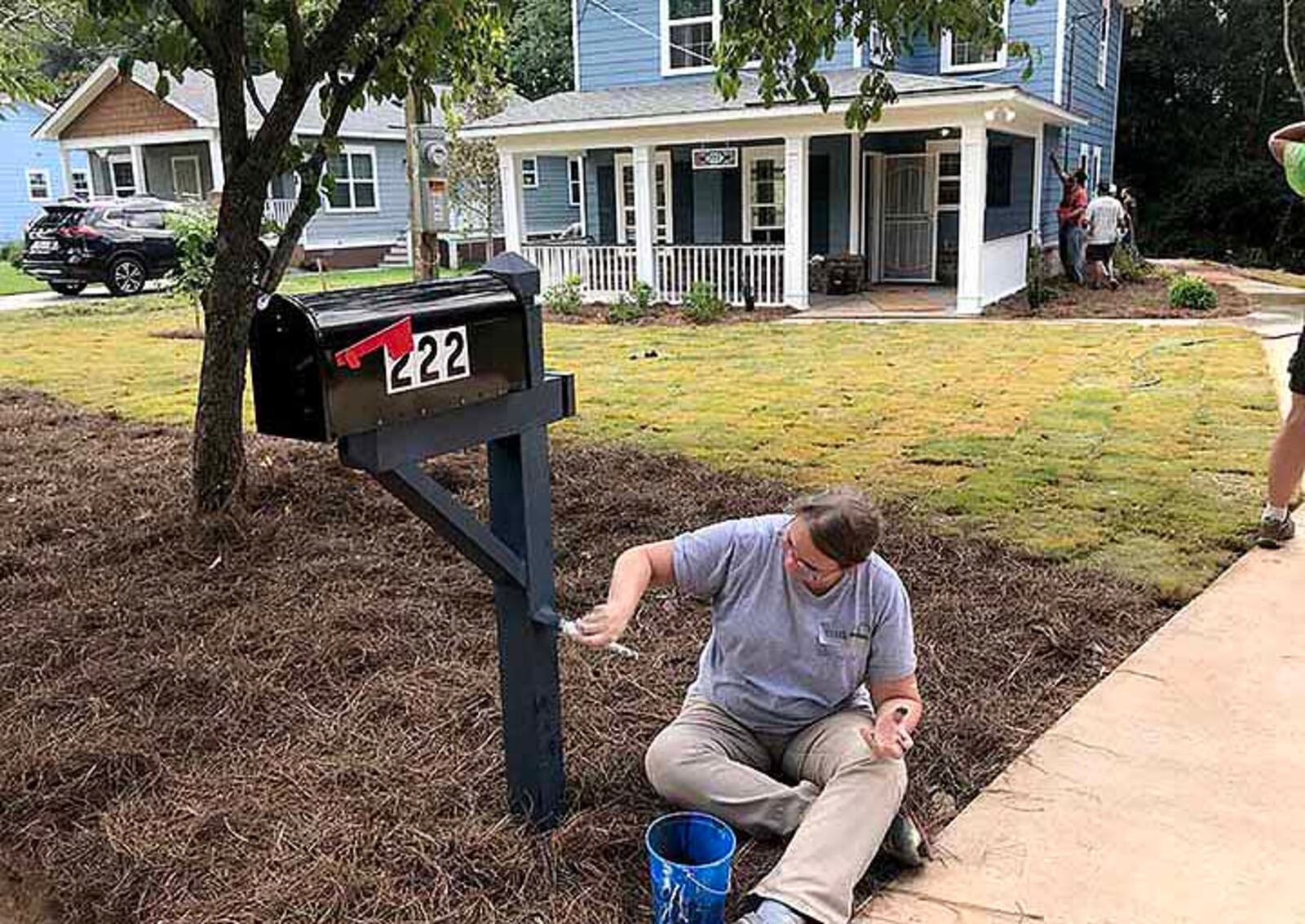 Volunteer Ellen Behm puts the finishing touches on the mailbox Saturday afternoon at a Habitat for Humanity home in southwest Atlanta. (Photo: Alexis Stevens/astevens@ajc.com)