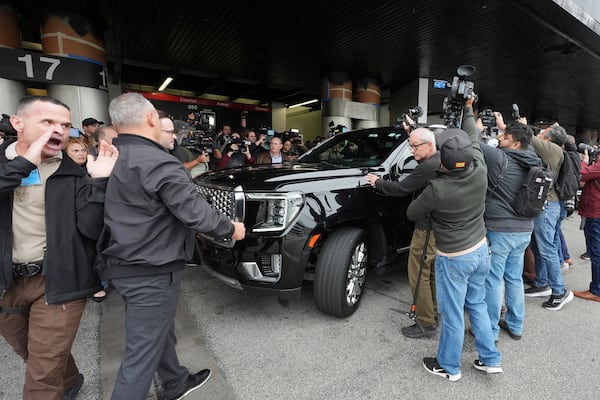 A car carrying Enrique Tarrio is surrounded by journalists at Miami International Airport, Wednesday, Jan. 22, 2025, in Miami. Tarrio was pardoned by President Donald Trump after he was convicted of seditious conspiracy for his role in the January 6 attack on the U.S. Capitol. (AP Photo/Marta Lavandier)