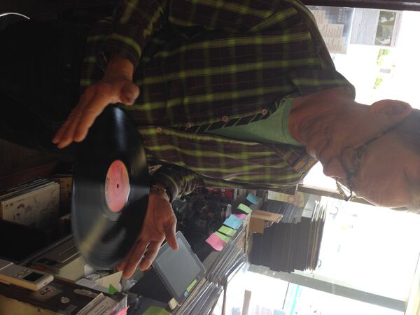 Don Radcliffe inspects a used album at Ella Guru in the Oak Grove neighborhood of Decatur.