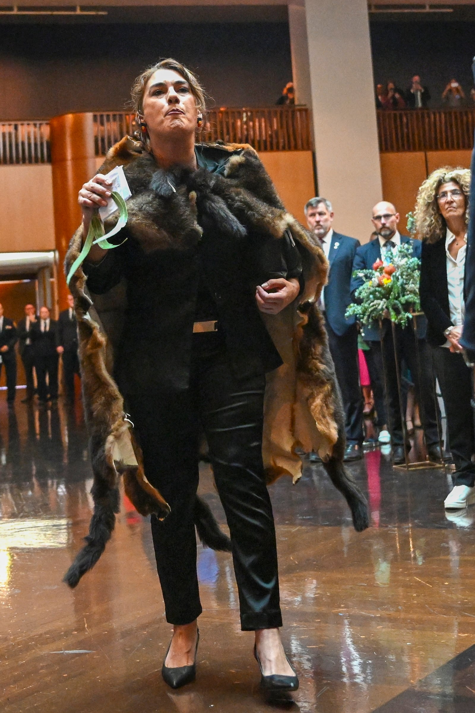 Australian Senator Lidia Thorpe, left, disrupts proceedings as Britain's King Charles and Queen Camilla attend a Parliamentary reception hosted by Australian Prime Minister Anthony Albanese and partner Jodie Jaydon at Parliament House in Canberra, Australia, Monday, Oct. 21, 2024. (Lukas Coch/Pool Photo via AP)