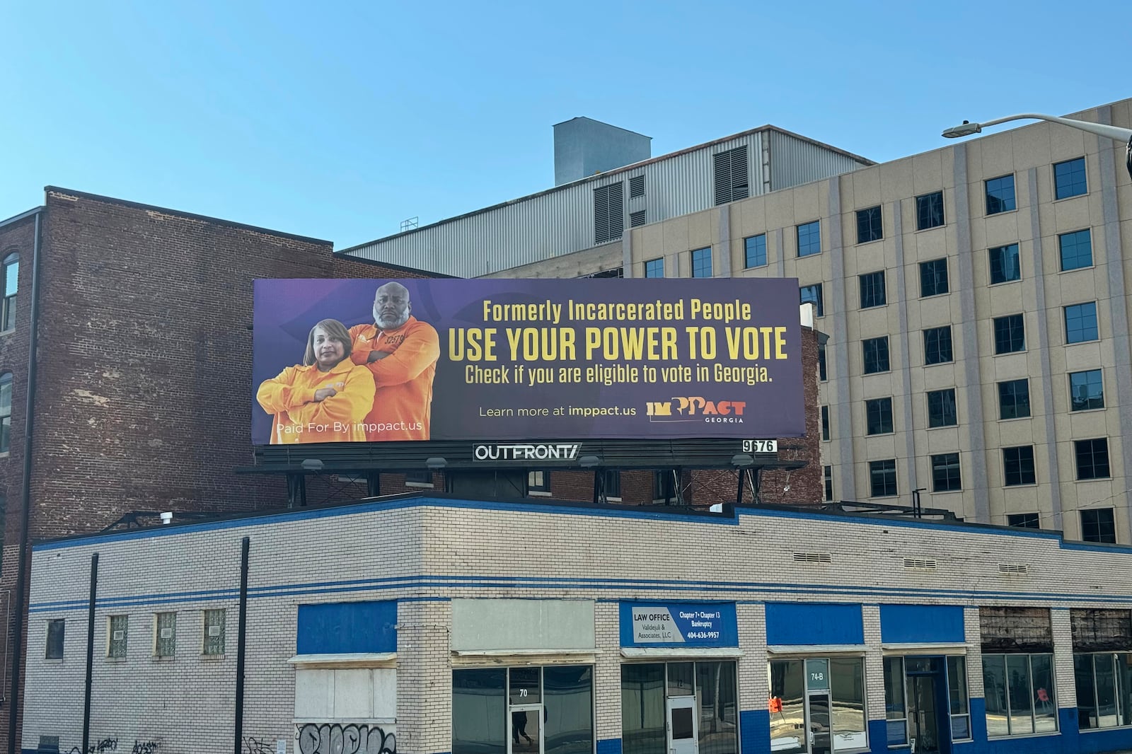 A billboard featuring Pamela Winn and Travis Emory Barber, encouraging people who have been incarcerated to vote, is displayed in Atlanta on Oct. 8, 2024. (AP Photo/Charlotte Kramon)