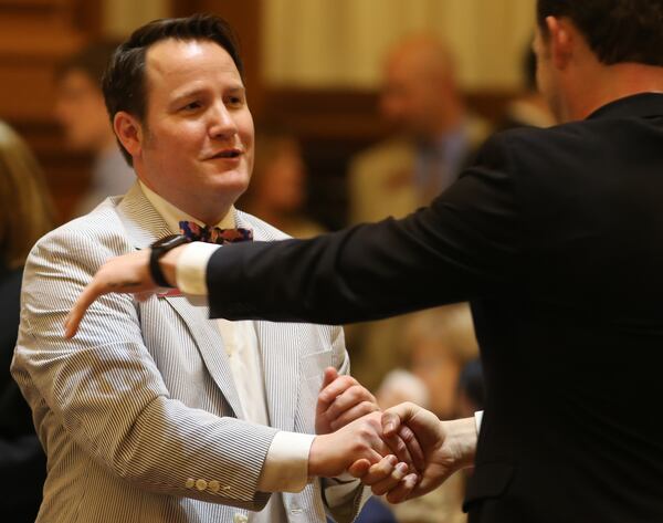 Rep. Scott Holcomb (D-Atlanta) shakes hands after the House passed the rape kit legislation he pushed in 2016 . Ben Gray / AJC