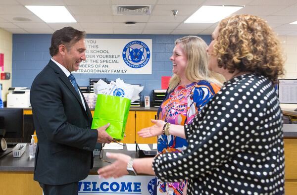 Incoming Fulton County Schools Superintendent Mike Looney accepts a parting gift from Jennifer Burton, principal of ECW, and Jill Meeker, assistant principal of ECW, as he leaves after touring Evoline C. West Elementary School during their summer school program in Fairburn, Ga., on Thursday, June 13, 2019. Looney's first official day on the job is Monday, June 17. Starting Monday, June 17, Looney will lead Georgia's fourth largest school district, which has a general fund budget of more than $1 billion. (Casey Sykes for The Atlanta Journal-Constitution)