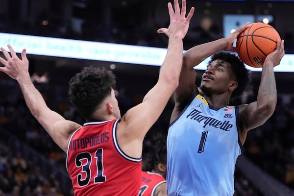 Marquette's Kam Jones shoots over St. John's's Lefteris Liotopoulos during the first half of an NCAA college basketball game Saturday, Mar. 8, 2025, in Milwaukee. (AP Photo/Morry Gash)