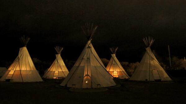 Fires burn in all five of the teepees in the predawn hour at El Cosmico in Marfa, Texas. (Guy Reynolds/Dallas Morning News/TNS)