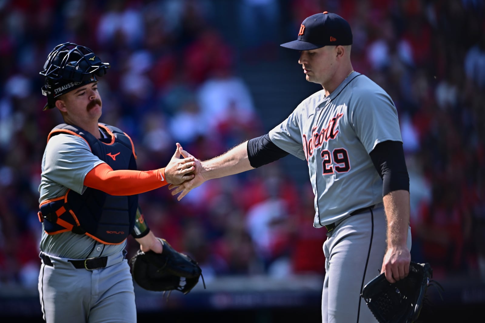 Detroit Tigers starting pitcher Tarik Skubal (29) is greeted by catcher Jake Rogers, left, as he walks off the mound during the first inning in Game 5 of baseball's American League Division Series against the Cleveland Guardians, Saturday, Oct. 12, 2024, in Cleveland. (AP Photo/David Dermer)