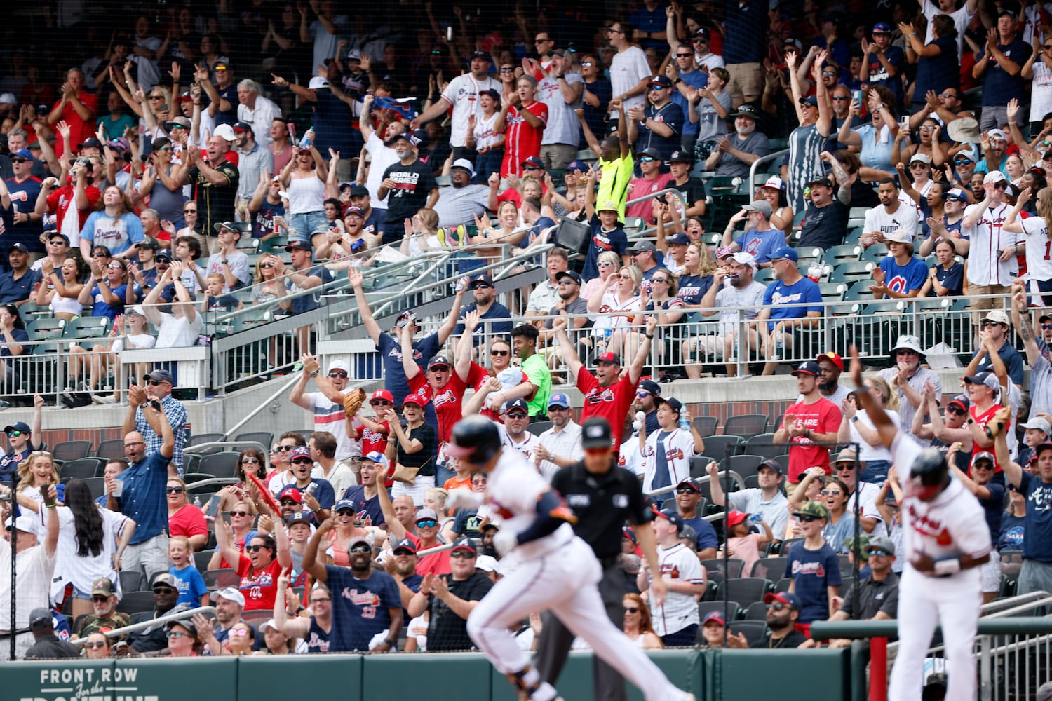 Fans jump from their seats after Atlanta Braves left fielder Adam Duvall hits a solo home run during the second inning Sunday, June 12, 2022, in Atlanta. (Miguel Martinez / miguel.martinezjimenez@ajc.com)