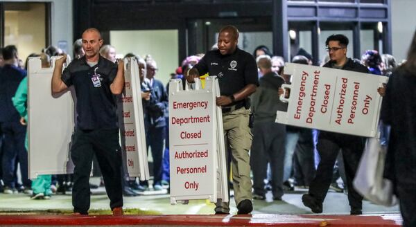 October 14, 2022 Atlanta: Medical workers embraced one another after closing Atlanta Medical Center’s emergency room. At about 5:30 a.m. Friday, Oct 14, 2022 the final patient to use Atlanta Medical Center’s emergency room walked out into downtown’s Old Fourth Ward neighborhood and turned onto Boulevard. At 7 a.m., staff locked the doors. (John Spink / John.Spink@ajc.com) 

