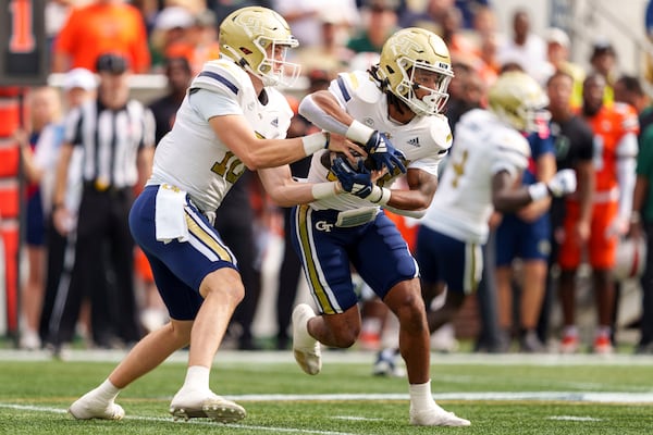 Georgia Tech quarterback Haynes King, left, fakes a handoff to running back Chad Alexander (27) during the first half of an NCAA college football game against Miami, Saturday, Nov. 9, 2024, in Atlanta. (AP Photo/Jason Allen)