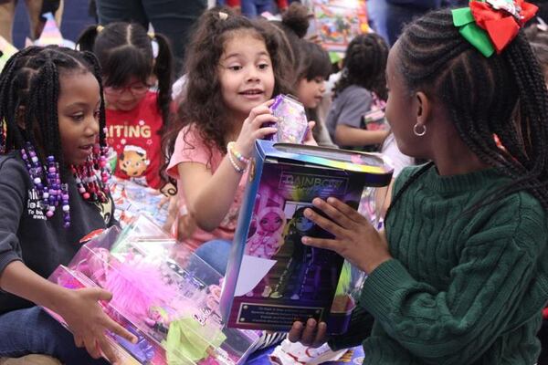 Kindergartners at Bryant Elementary School compare gifts they have just opened from the Cobb County Sheriff’s Office. (Photo Courtesy of Joe Adgie)