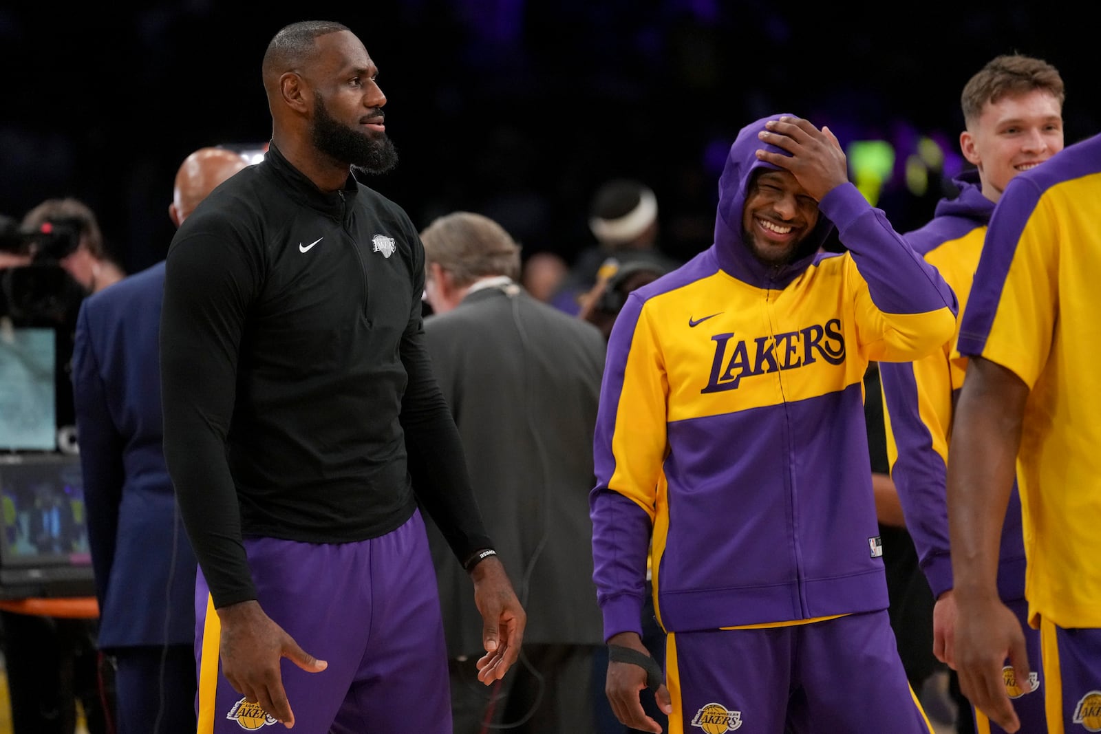 Los Angeles Lakers forward LeBron James, left, and his son, guard Bronny James warm up prior to an NBA basketball game against the Phoenix Suns in Los Angeles, Friday, Oct. 25, 2024. (AP Photo/Eric Thayer)