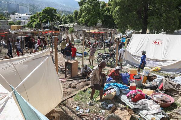 Residents of the Nazon neighborhood displaced by gang violence construct a tent encampment, in Port-au-Prince, Haiti, Friday, Nov. 15, 2024. (AP Photo/Odelyn Joseph)