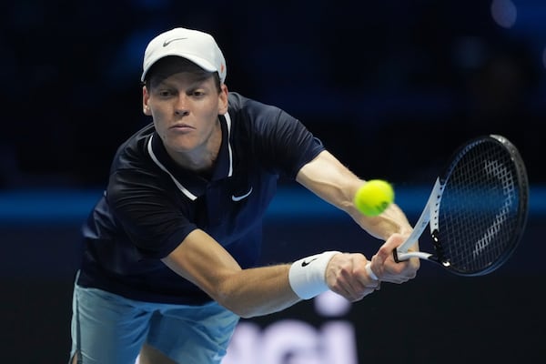 Italy's Jannik Sinner returns the ball to Australia's Alex de Minaur during their singles tennis match of the ATP World Tour Finals at the Inalpi Arena, in Turin, Italy, Sunday, Nov. 10, 2024. (AP Photo/Antonio Calanni)