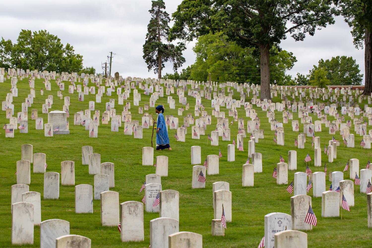 Alexandria Quillen comes from a military family and feels spiritually led to pay respect and lay flowers at the graves of soldiers in the Marietta National Cemetery on Monday, May 29, 2003. The National Memorial Day Association of Georgia holds the 77th annual Memorial Day Observance at the national cemetery.  (Jenni Girtman for The Atlanta Journal-Constitution)