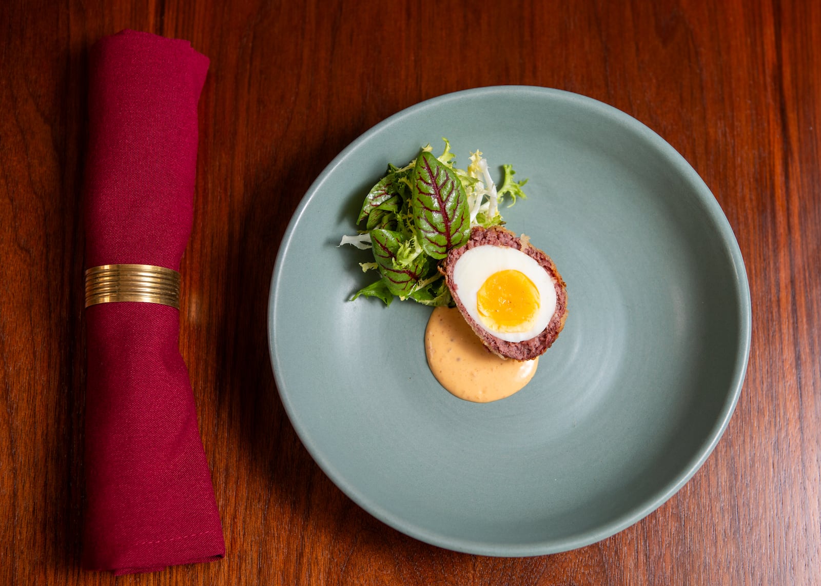 Kevin Gillespie's Scotch Eggs feature perfectly cooked eggs wrapped in a sausage-bacon mixture. (Aaliyah Man for The Atlanta-Journal Constitution)