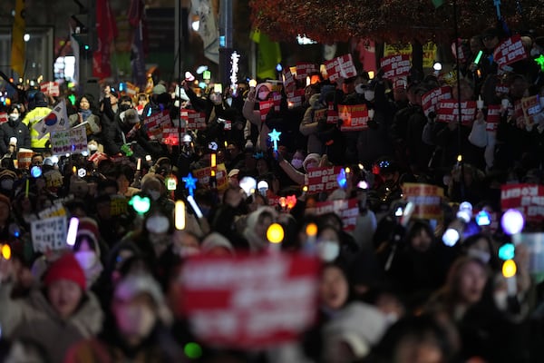 Participants gather to stage a rally demanding South Korean President Yoon Suk Yeol's impeachment, in front of the headquarters of the ruling People Power Party in Seoul, South Korea, Tuesday, Dec. 10, 2024. The banners read "Immediately impeachment Yoon Suk Yeol." (AP Photo/Lee Jin-man)