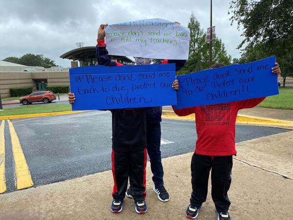 Fulton County Schools teachers and children protest the district's plan of returning to face-to-face instruction with a walkout during lunch on Thursday, Sept. 17, 2020.