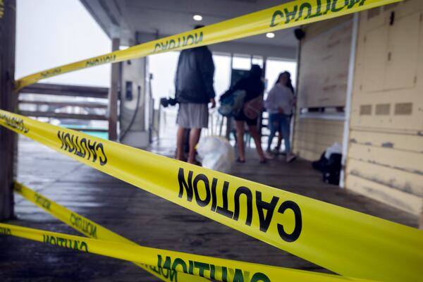 Staff and boat owners at Bull River Marina talk to marina staff after securing their sailboat as Hurricane Idalia's outer bands of wind and rain hit the coast Wednesday in Savannah.