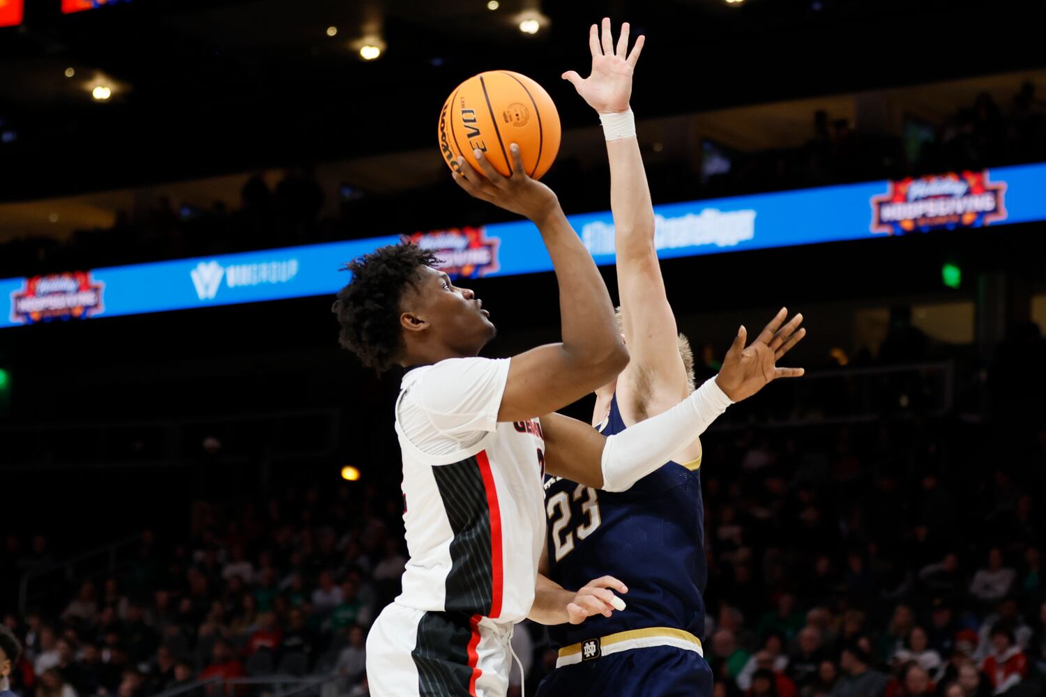 Bulldogs forward Matthew-Alexander Moncrieffe goes up for a shot against Fighting Irish guard Dane Goodwin during the second half Sunday night at State Farm Arena. (Miguel Martinez / miguel.martinezjimenez@ajc.com)