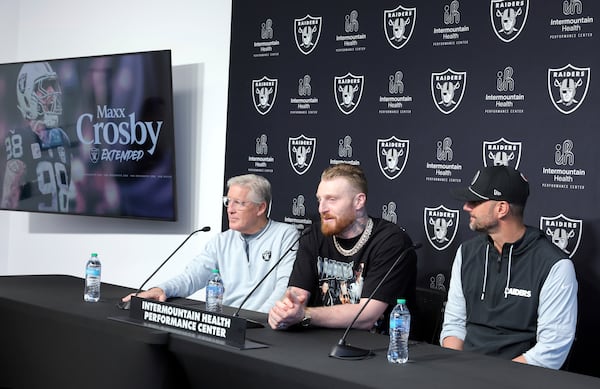 Las Vegas Raiders defensive end Maxx Crosby, center, speaks during an NFL football news conference with head coach Pete Carroll, left, and general manager John Spytek, Wednesday, March 5, 2025, in Henderson, Nev. (Steve Marcus/Las Vegas Sun via AP)