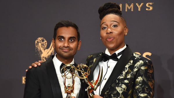 Aziz Ansari (L) and Lena Waithe pose with the award for Outstanding Writing for a Comedy Series for 'Master of None' during the 69th Annual Primetime Emmy Awards Sept. 17.