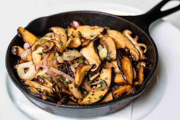 At the Brasserie at Bazati, an appetizer of wild mushrooms is rushed from the kitchen still sizzling in their skillet. CONTRIBUTED BY HENRI HOLLIS