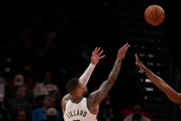 Milwaukee Bucks guard Damian Lillard (0) shoots the ball in the first half of an NBA basketball game against the Atlanta Hawks, Tuesday, March 4, 2025, in Atlanta. (AP Photo/Brynn Anderson)