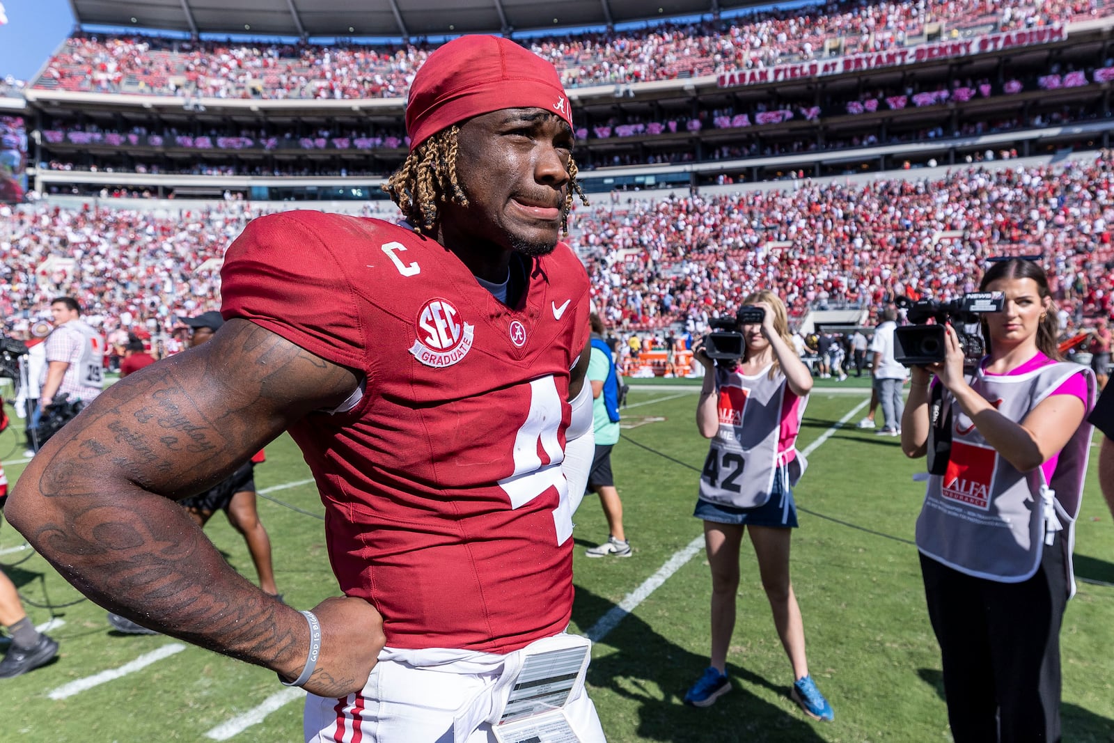 Alabama quarterback Jalen Milroe (4) waits for an interview with ESPN following a close win over South Carolina in an NCAA college football game, Saturday, Oct. 12, 2024, in Tuscaloosa, Ala. (AP Photo/Vasha Hunt)