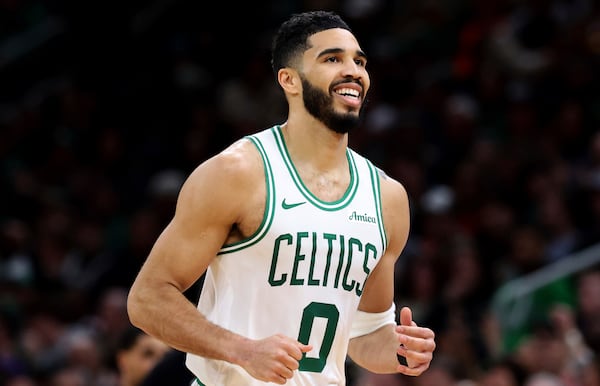 Boston Celtics forward Jayson Tatum (0) smiles after sinking a three-point shot during the first half of an NBA basketball game against the Los Angeles Lakers, Saturday, March 8, 2025, in Boston. (AP Photo/Mark Stockwell)