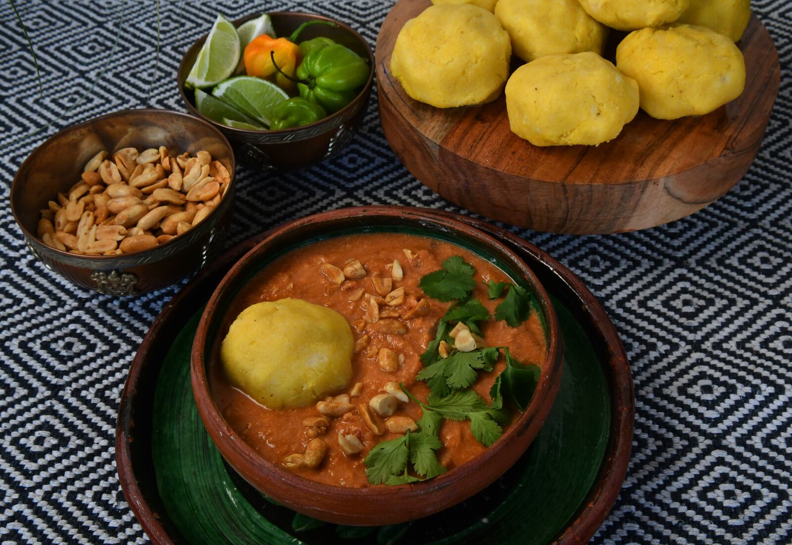 Enjoy some West African-inspired cuisine on a fall evening with Peanut Soup with fufu (fonio and cassava dumplings). (Styling by Lisa Hanson / Chris Hunt for the AJC)