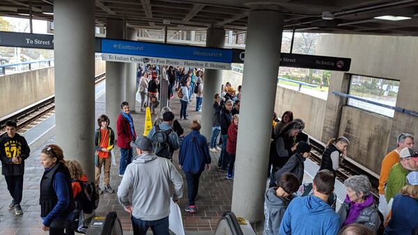 Something you never see: lines at the MARTA ticket kiosks at Decatur's East Lake station. An even rarer site: crowds on the platform pushing onto the downtown-bound Atlanta train. "Jeez," said one middle-aged woman boarding at the next station, with an older couple. They joined a train car filled with a cross-generational crowd: teenagers, moms and dads, grandparents. "This idea of among teachers is crazy," one man says.