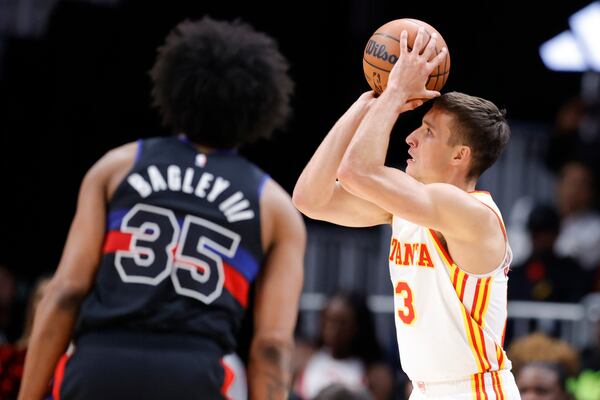 Atlanta Hawks guard Bogdan Bogdanovic, right, shoots as Detroit Pistons forward Marvin Bagley III watches during the second half of an NBA basketball game Tuesday, March 21, 2023, in Atlanta. (AP Photo/Alex Slitz)