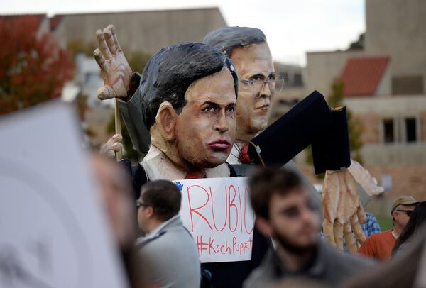 Giant puppets of Republican presidential candidates Marco Rubio and Jeb Bush are displayed in the "Free Speech Zone" outside of the GOP presidential debate on Wednesday, Oct. 28, 2015, at the Coors Event Center on the University of Colorado campus in Boulder, Colo. (Jeremy Papasso/Daily Camera via AP) NO SALES; MANDATORY CREDIT