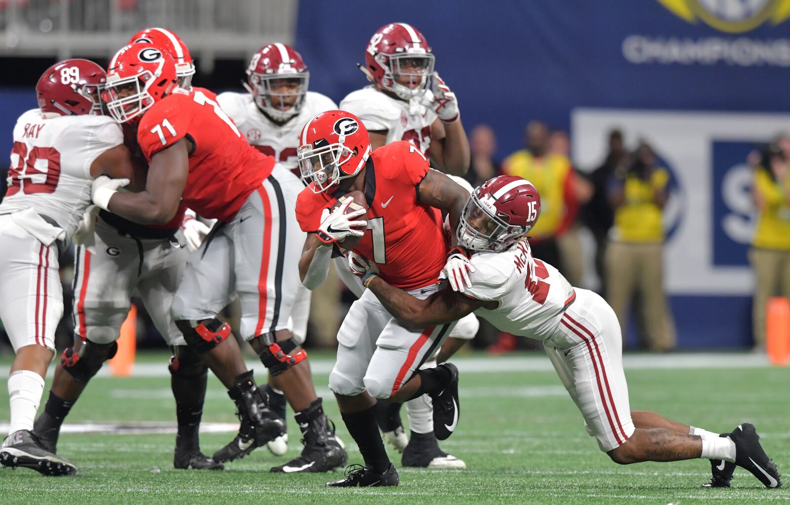 December 1, 2018 Atlanta - Georgia running back D'Andre Swift (7) gets tackled from behind by Alabama defensive back Xavier McKinney (15) during the first half of the SEC Football Championship at Mercedes-Benz Stadium on Saturday, December 1, 2018. HYOSUB SHIN / HSHIN@AJC.COM