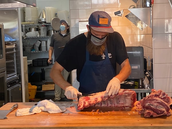 Kinship butcher Stephen Wagner breaks down half of a cow. The whole-animal butchery sources all of its proteins from Georgia farms. Ligaya Figueras/ligaya.figueras@ajc.com